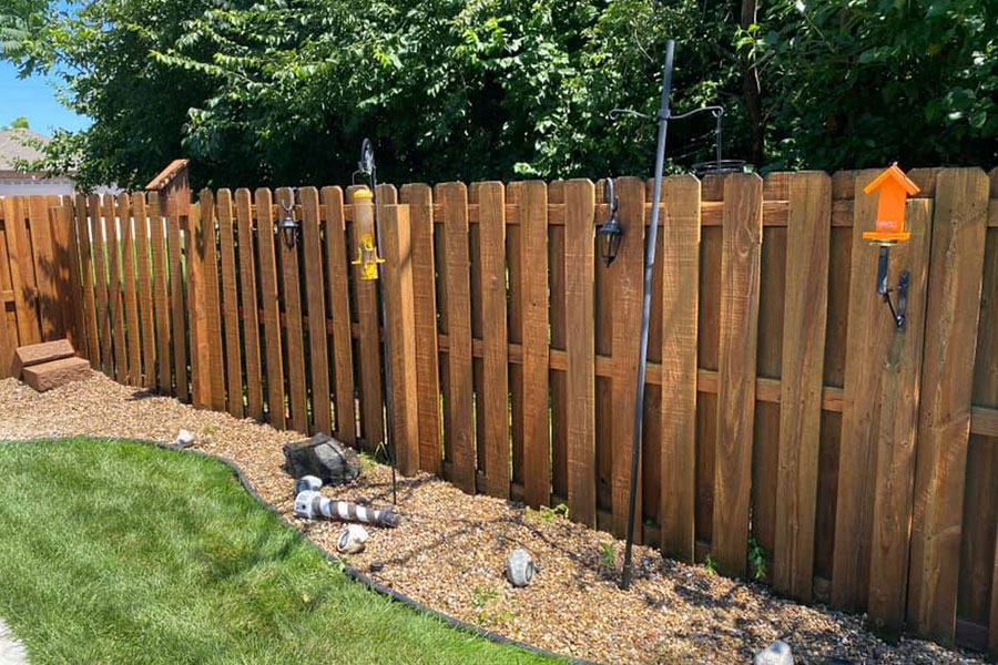 A freshly power-washed wooden fence in Springfield, IL that has been cleaned by Petersburg Power Washing.
