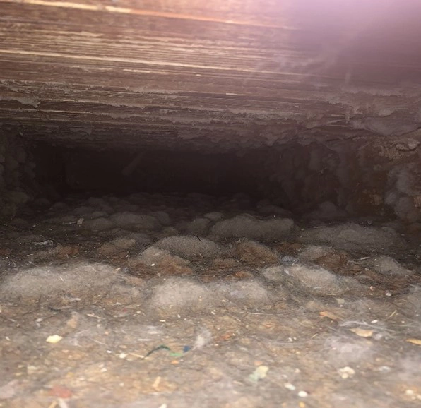 a dirty air duct before air duct cleaning services in Petersburg, IL