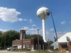 This is a photo of buildings in Roseville, IL with their city’s water tower in the background.